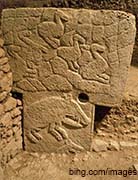 image of a pillar with carvings of animals on it at gobekli tepi